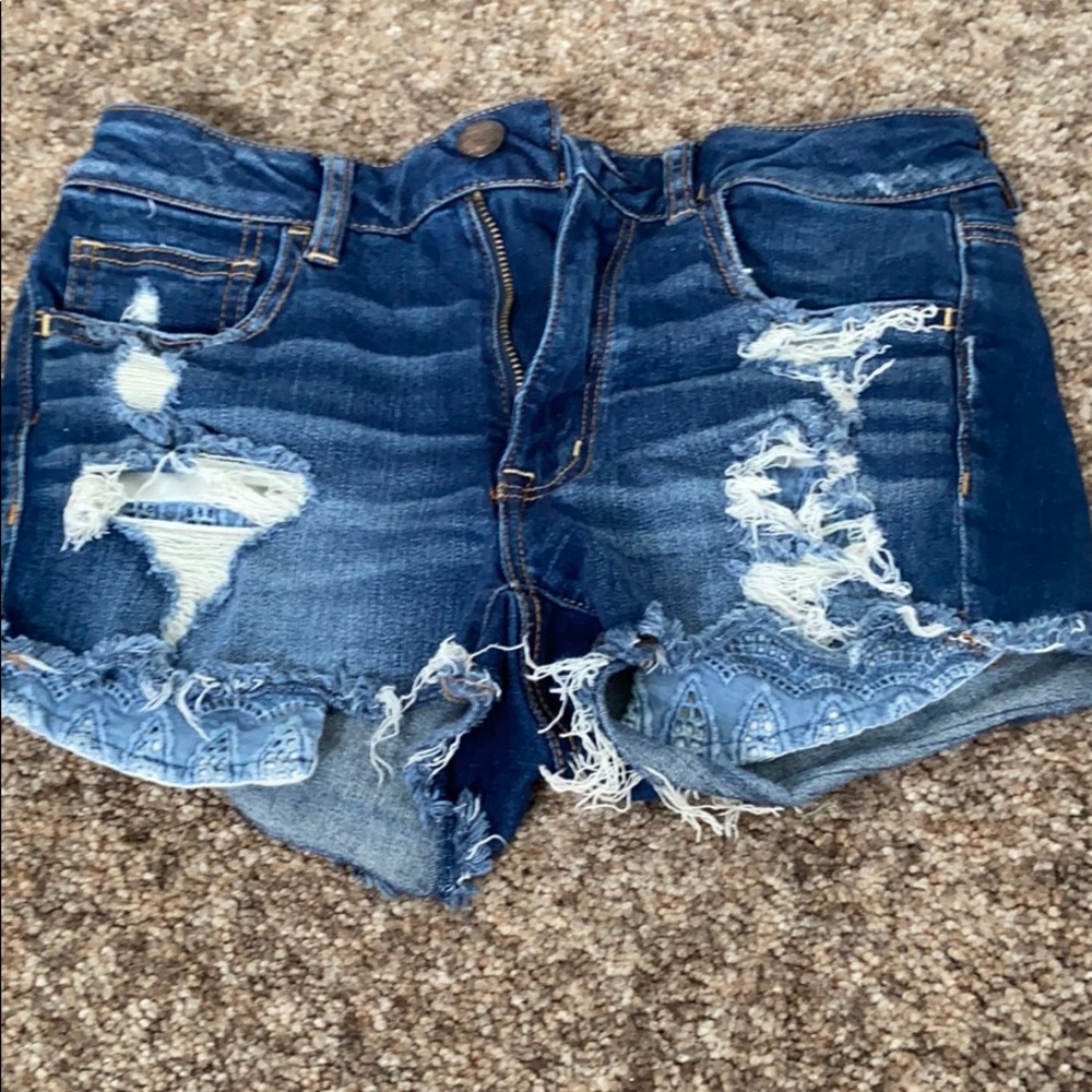 Ripped jean shorts with pocket details. Size 6.
